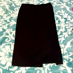 High waisted, black skirt with a slight